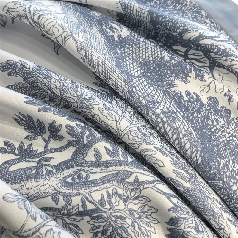 a sleek silver zipper on a eucalyptus fiber duvet cover with white fabric track set against sage green bedding