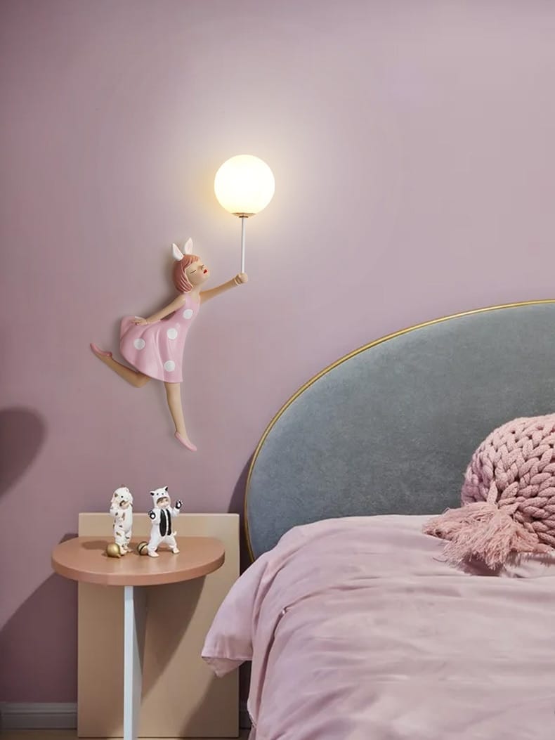 Whimsical pink polka dot fairy girl wall lamp featuring a glowing spherical bulb designed as a girl wall lamp for bedroom decor.