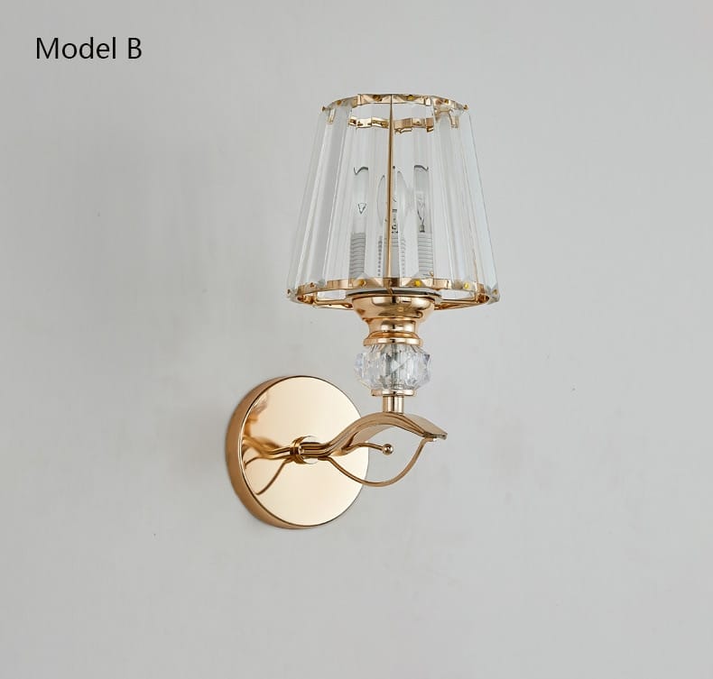 Modern minimalist wall sconce featuring a gold-toned curved arm and a crystal-encrusted lampshade designed as a minimalist wall lamp for bedroom use.