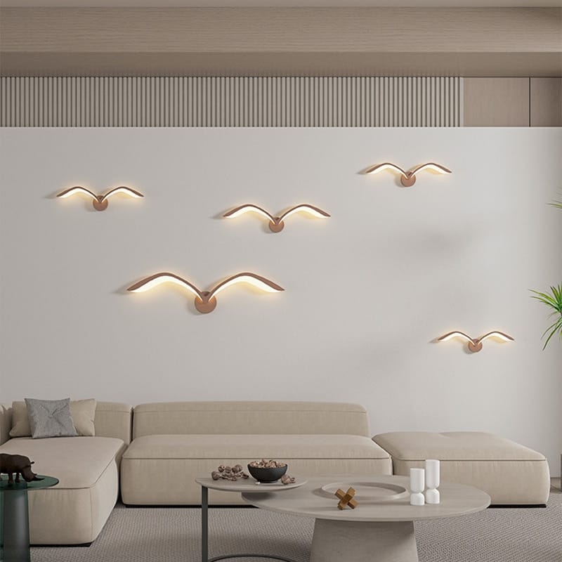 five modern gold-toned seagull-shaped wall lamps with warm led lighting in nordic avian style for indoor use