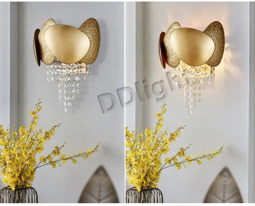 Luxury gold crystal led ceiling chandelier featuring a gold-toned wall sconce with textured cat ear shaped metal arms and dangling crystal droplets for living room decor.