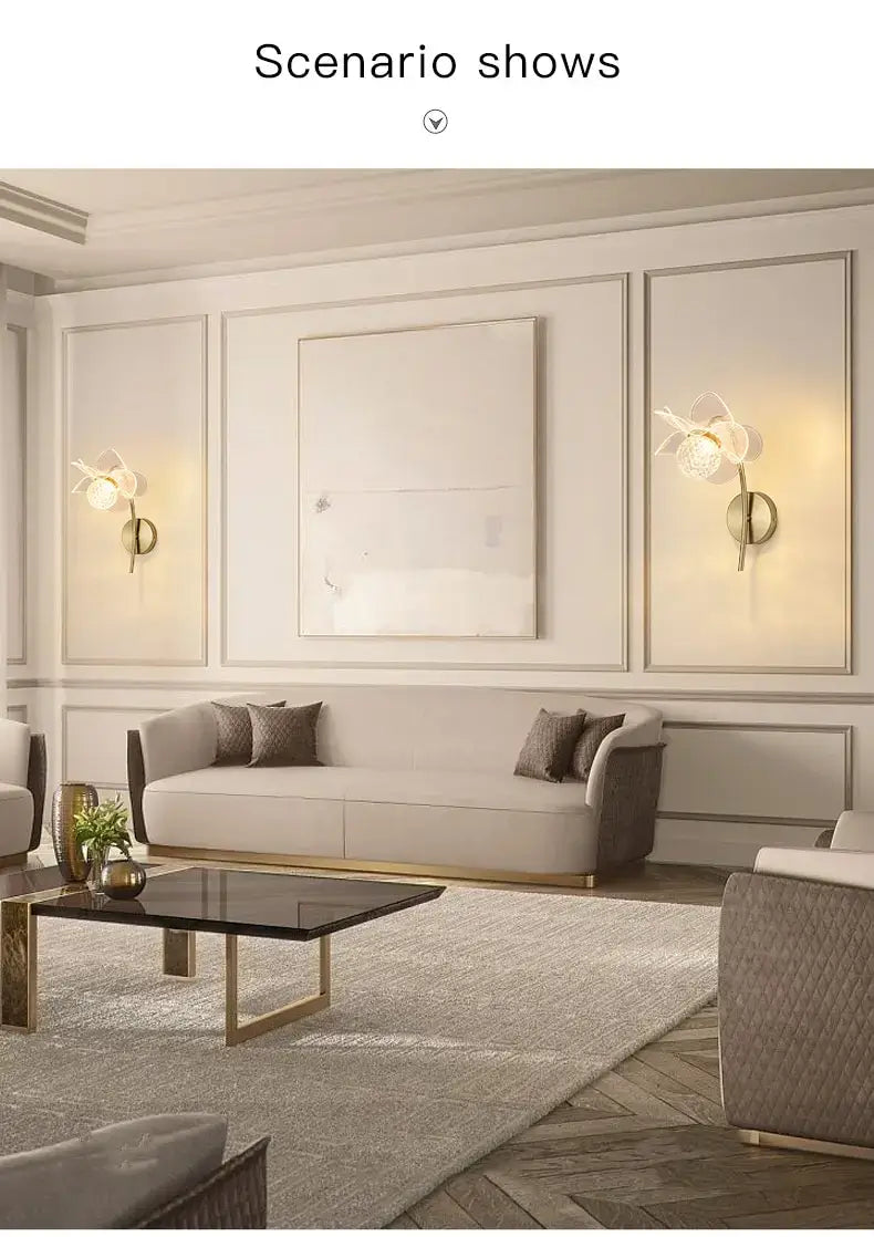 Beige upholstered sofa with gold-tone legs and matching throw pillows complemented by a creative floral decorative gold led wall lamp in a bedroom setting.