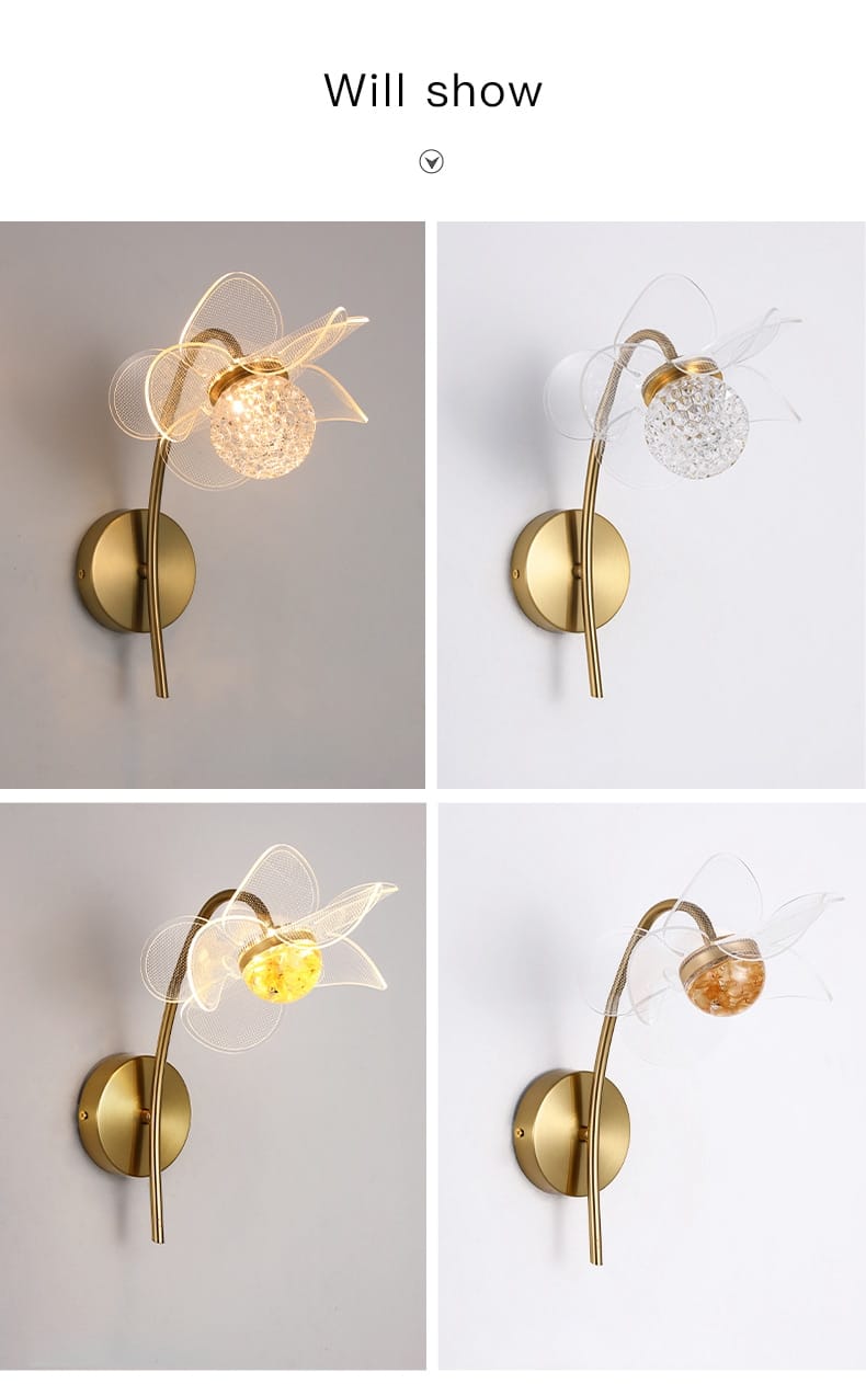 Creative floral decorative gold led wall lamp with a curved stem, clear crystal globe bulb holder, and translucent white flower-shaped accents for bedroom use.