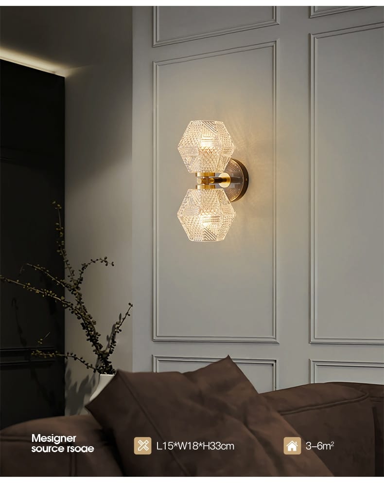 Gold-toned postmodern luxury led wall lamp featuring two hexagonal faceted crystal shades designed as a luxury led wall sconce for bedroom lighting.