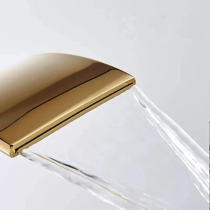 Grifo monomando para lavabo DecorBites™ Gold Waterfall, con cabezal de latón y sistema de sujeción.
