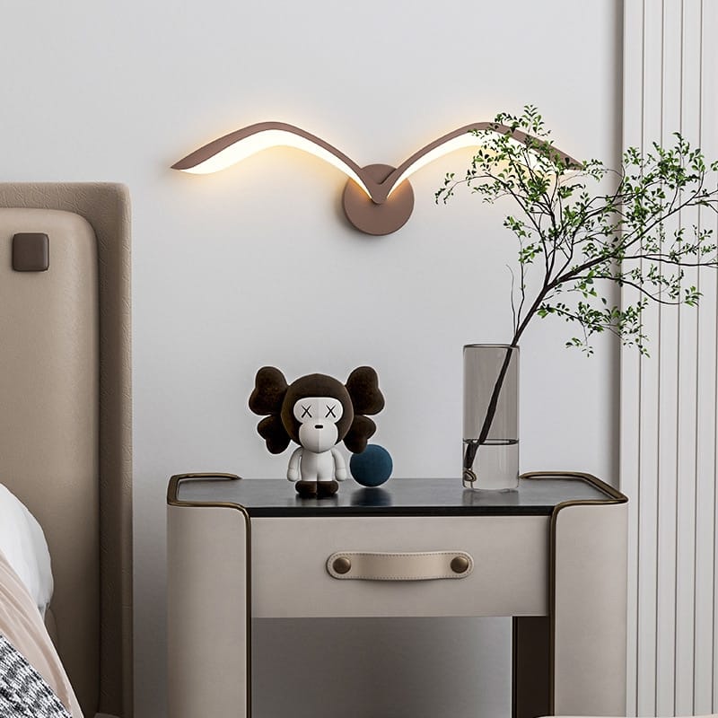 modern white nordic avian style wall lamp with a sleek curved wing design emits warm ambient lighting for style indoor use