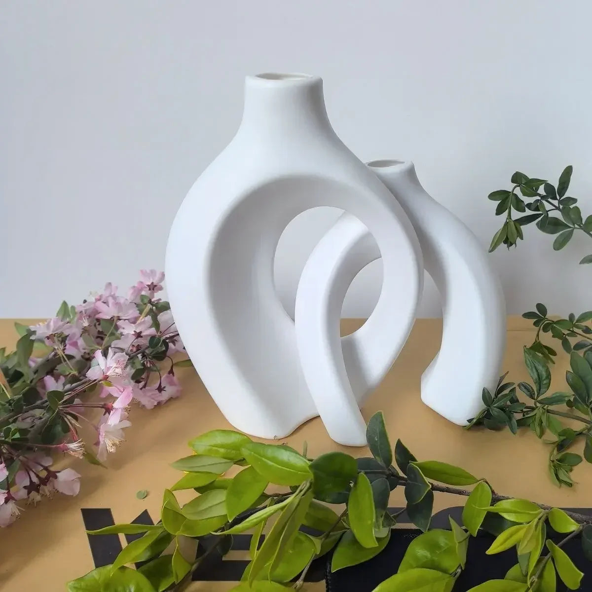 White ceramic vase with sleek abstract interlocking curved design from mainland china for modern home decor