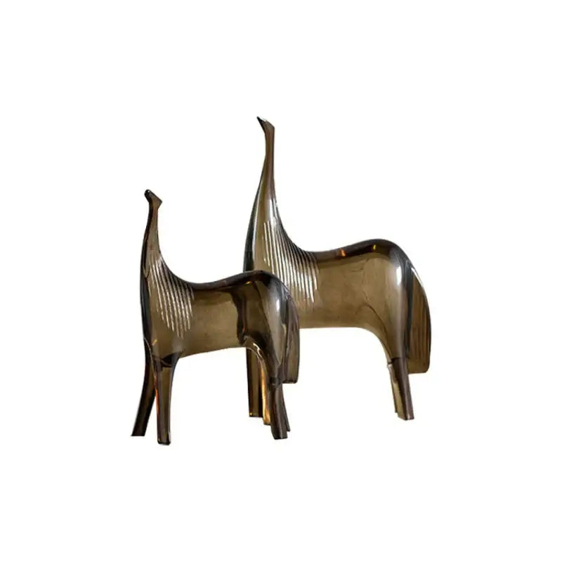 Two sleek amber glass horse couple figurines with minimalist design and vertical ridges in sculpture set decorbites horse couple