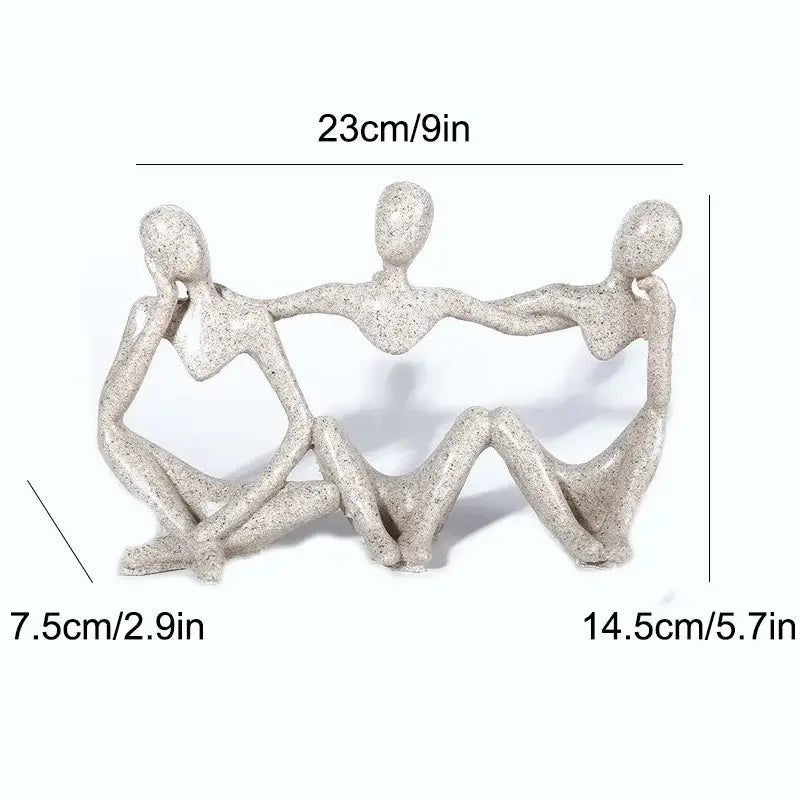 Gray speckled resin abstract friendship figurine of three human figures holding hands in a heart shape for living room decor