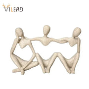 Beige textured resin abstract friendship figurine featuring three connected seated figures for living room decor