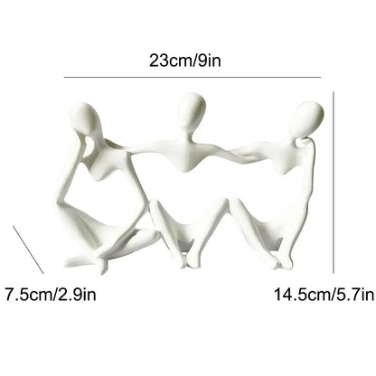 White ceramic abstract friendship figurine depicting three connected seated figures for living room decor