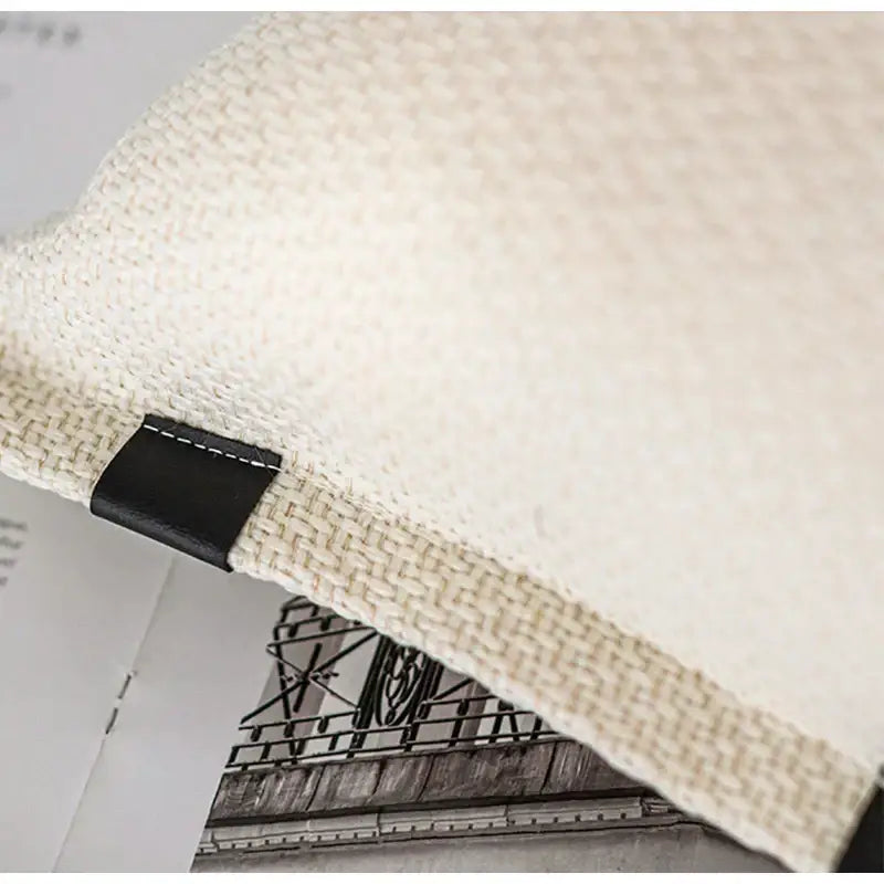 Beige textured pillow cover made of woven fabric with black leather tag for living room decorbites beige textured design
