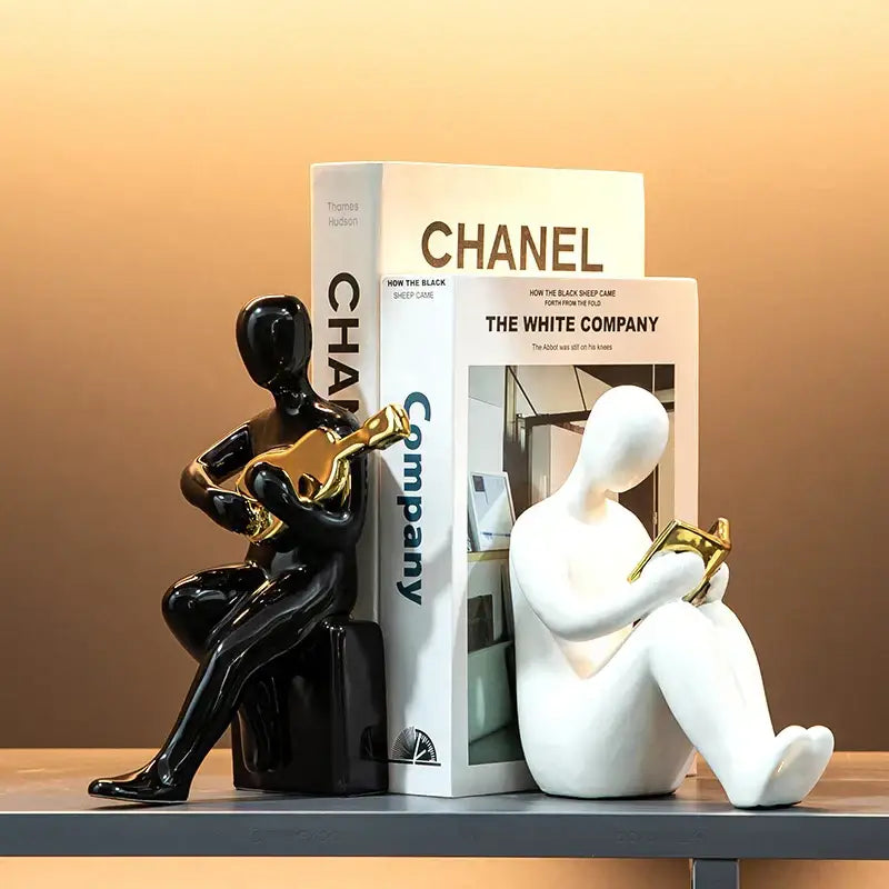 Abstract black and gold character bookends featuring a seated musician playing guitar in nordic style decorbites decor