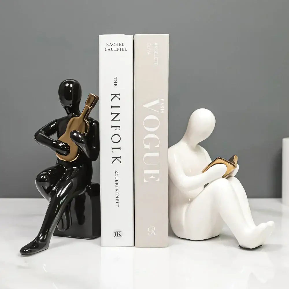 Black glossy ceramic character bookends of a seated musician with gold accents for decorbites abstract nordic style decor