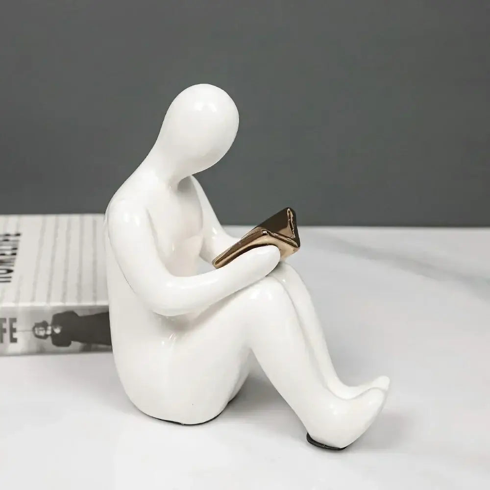 White ceramic figurine holding gold book character bookends in abstract nordic style for office decorbites decor