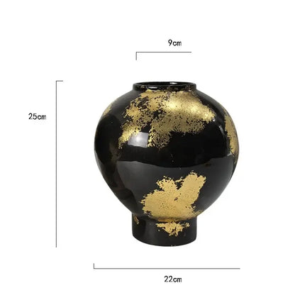 A glossy black ceramic vase with gold foil pattern accents measuring 25cm for living room decor
