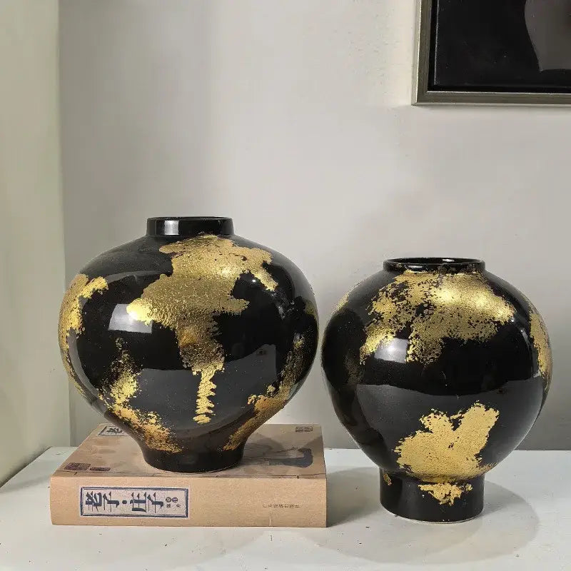 Two glossy black ceramic vases with irregular gold foil pattern ideal for living room decor and display