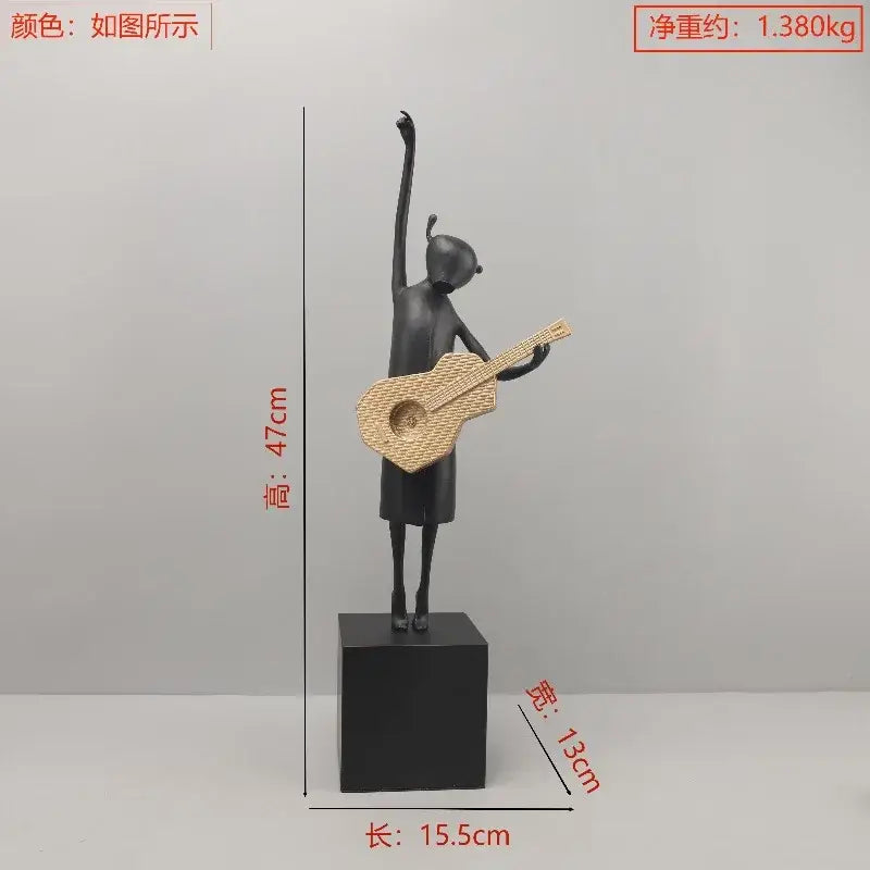 Abstract black and gold guitarist resin sculpture featuring a stylized girl holding a woven wicker guitar on a black base
