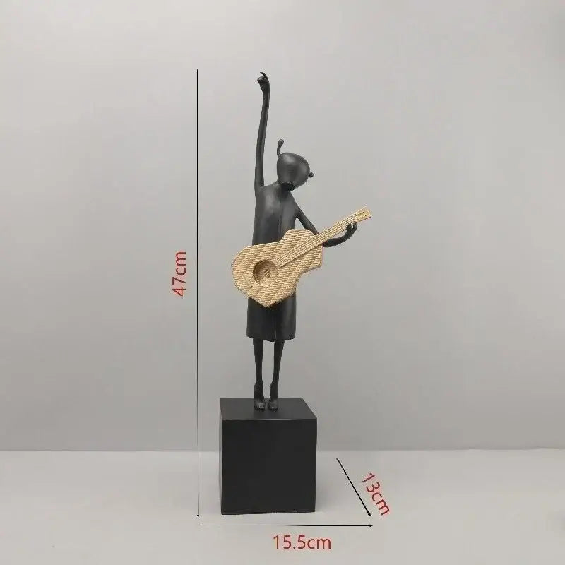 Abstract black and gold guitarist resin sculpture featuring a stylized girl holding a woven wicker guitar on a black base