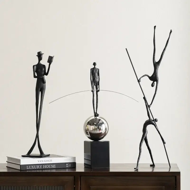 Black metal human figure sculpture of a man in a top hat holding a book decorbites living room decor