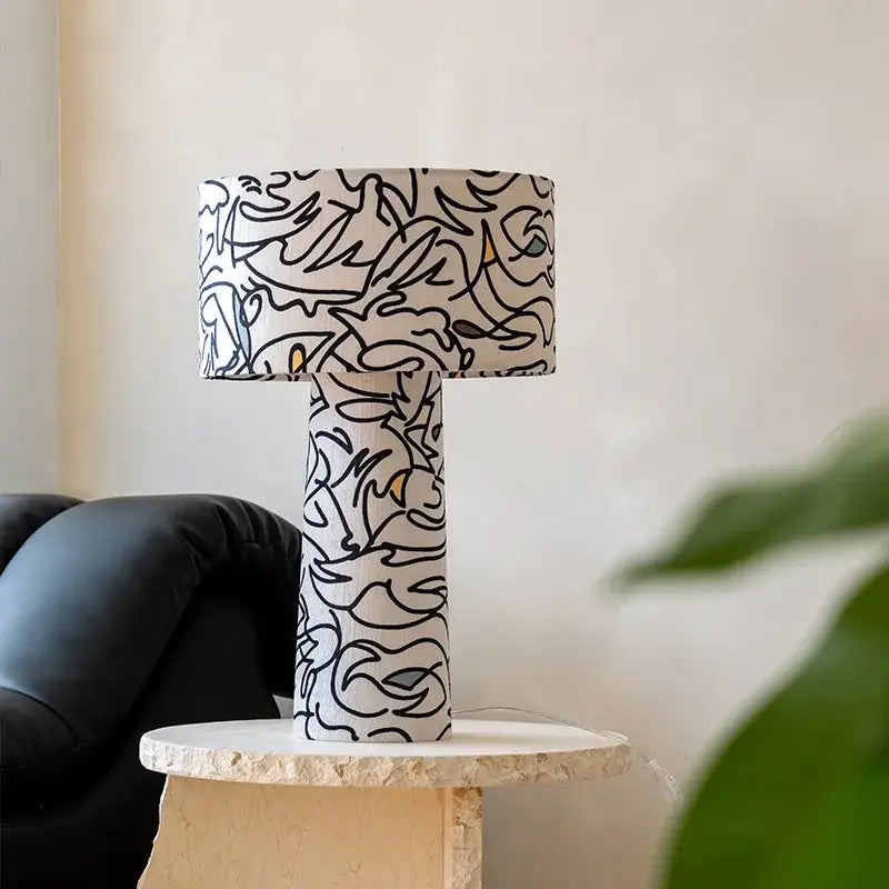 A modern study lamp with abstract black line art on white fabric by decorbites designer french medieval for bedroom decor