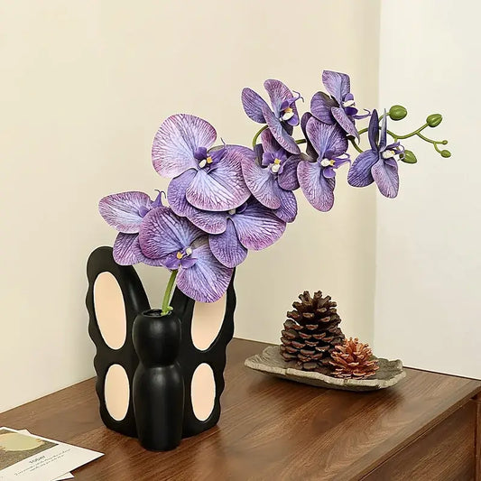 Black butterfly ceramic vase shaped like a black bunny with cream cutouts holding purple orchid for living room decorbites black butterfly decor