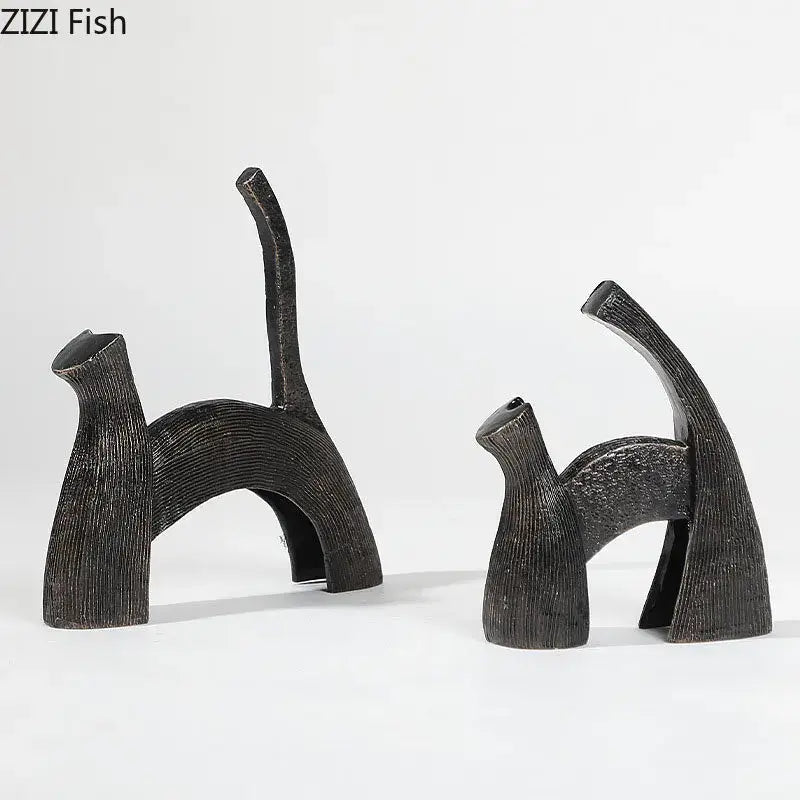 Two abstract black cast iron cat figurines with textured ribbed surfaces for decorbites bull statue living room decor