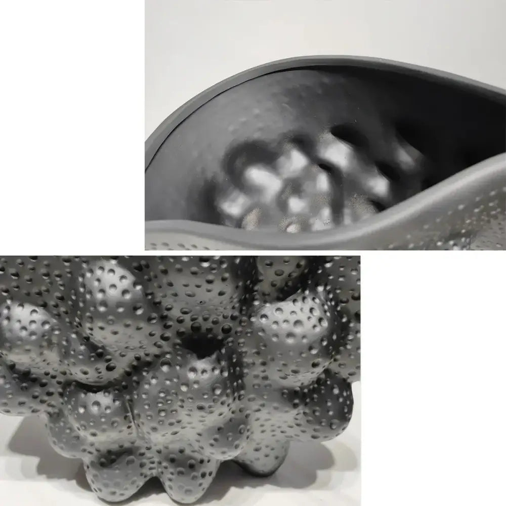 Gray silicone massage ball with textured bumpy surface and raised dots paired with decorbites black ceramic pleated vase