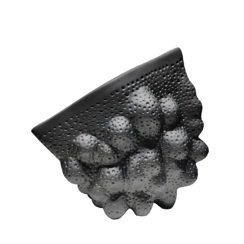 Black ceramic pleated wall-mounted shelf with textured perforated surface and rounded protrusions for modern decorbites decor