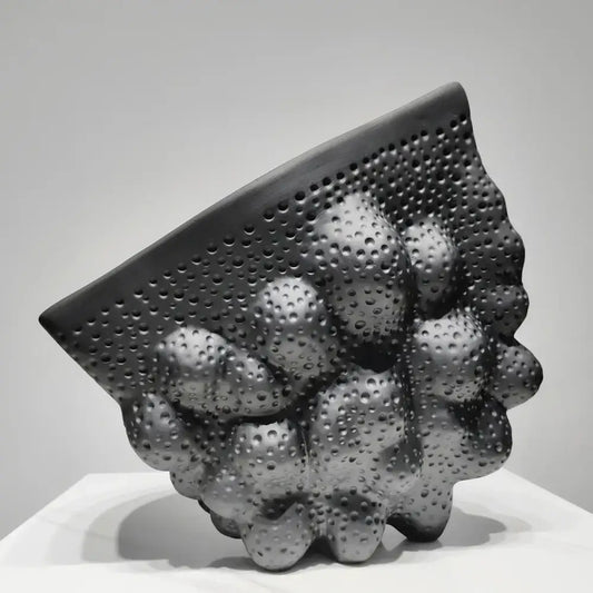 Abstract black ceramic pleated vase with textured bubble-like protrusions for living room decorbites black ceramic sculpture