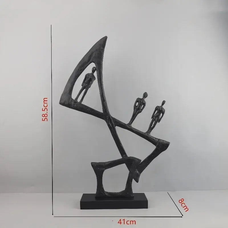 Black abstract cast iron sculpture featuring three stylized human figures balanced on interconnected geometric forms for home decor geometric couple decorbites geometric couple