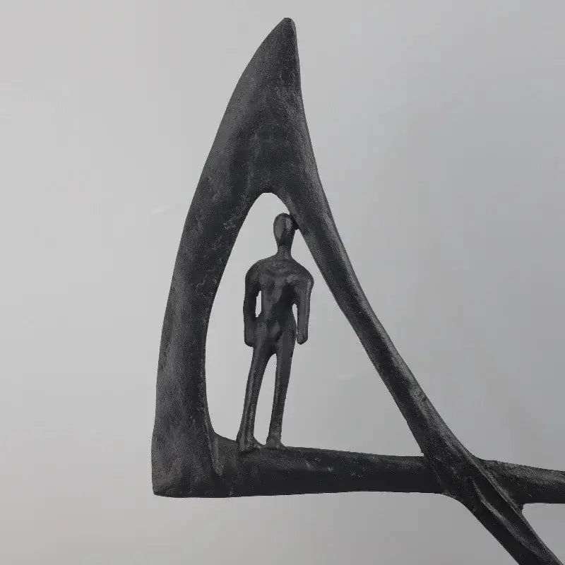 Abstract black geometric couple cast iron sculpture featuring a stylized human figure in triangular frame for home decor