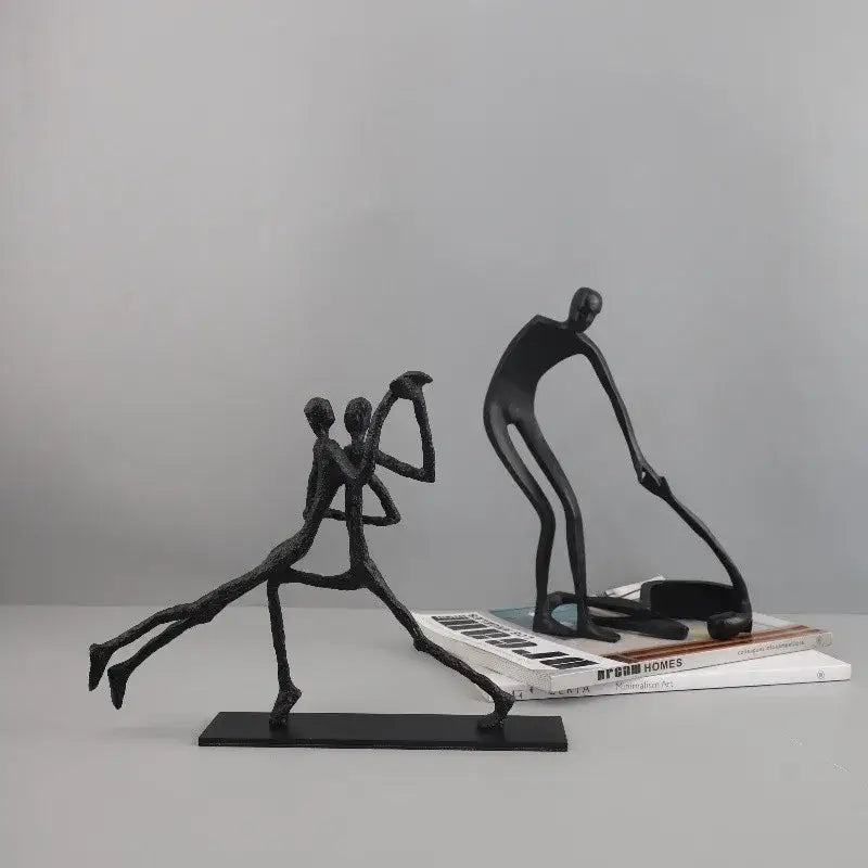 Black abstract geometric couple cast iron sculpture featuring two stylized figures in dynamic poses for home decor