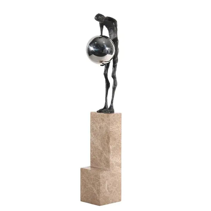 A sleek dark bronze gymnast metal handicraft figure holding a silver sphere on a beige marble pedestal for decorbites gymnast metal decor