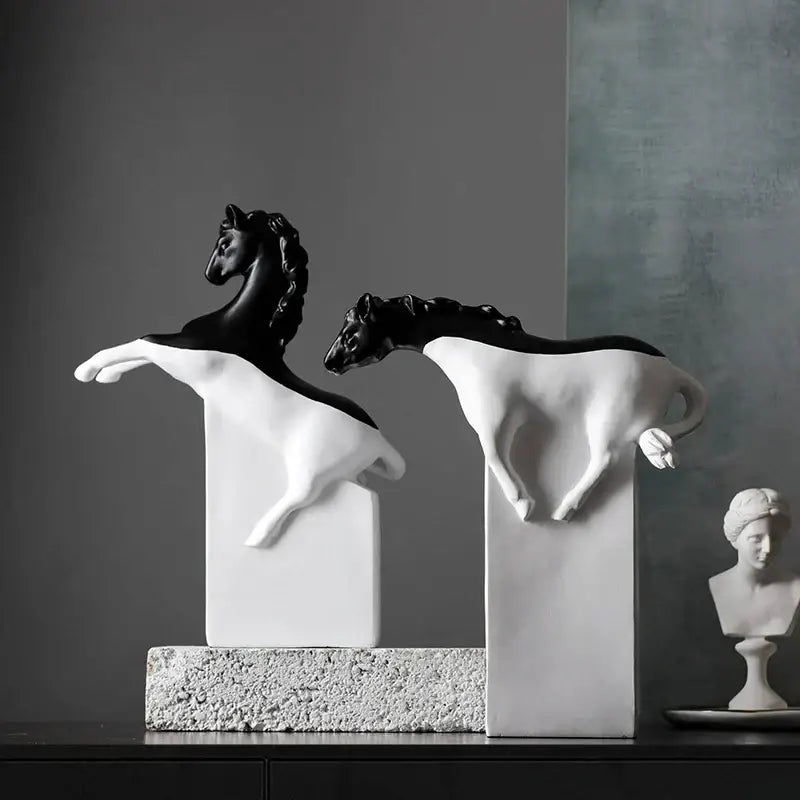 Two sleek black and white horse abstract sculptures on pedestals ideal for decorbites golden horse living room decor