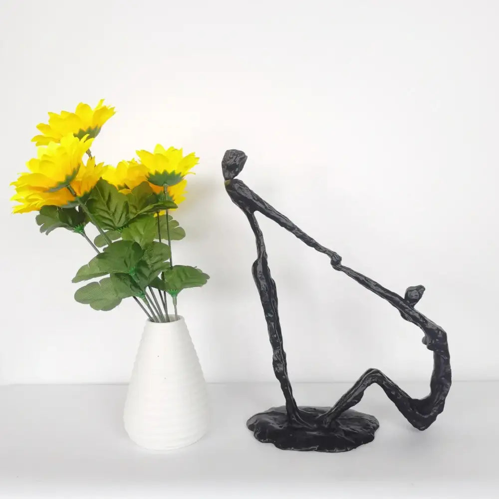 Abstract black hand dance sculpture of two intertwined figures on a base for living room adolescence decor