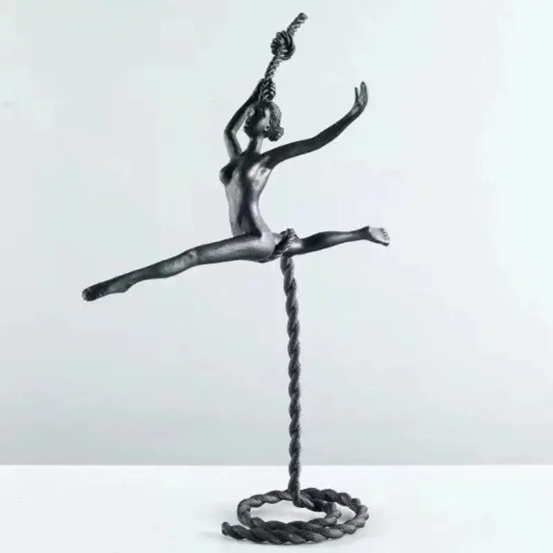 Abstract black metal ballerina dancer sculpture suspended mid-air on a twisted rope base for living room decorbites decor