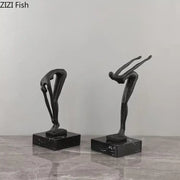 Two sleek black metal abstract gymnast statue desk ornaments on polished dark marble bases for decorbites decorbites gymnast statue