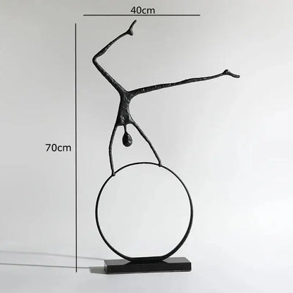 Abstract black metal sports figure sculpture in black metal balancing on a circular ring for decorbites living room decor