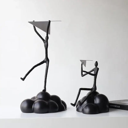 Black metal abstract figurines balancing resin paper airplane clouds for living room decor