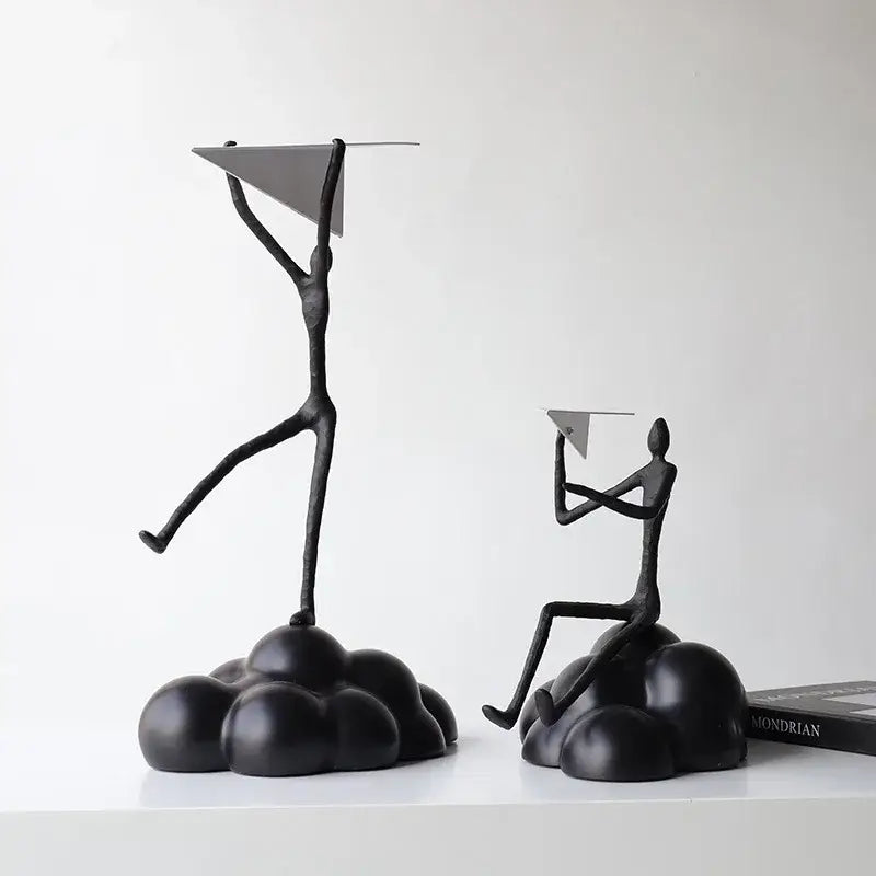 Black metal abstract figurines balancing resin paper airplane clouds for living room decor