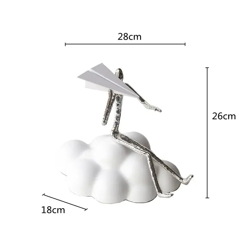 Silver metallic figurine sitting on white resin paper airplane cloud holding paper airplane for living room decor