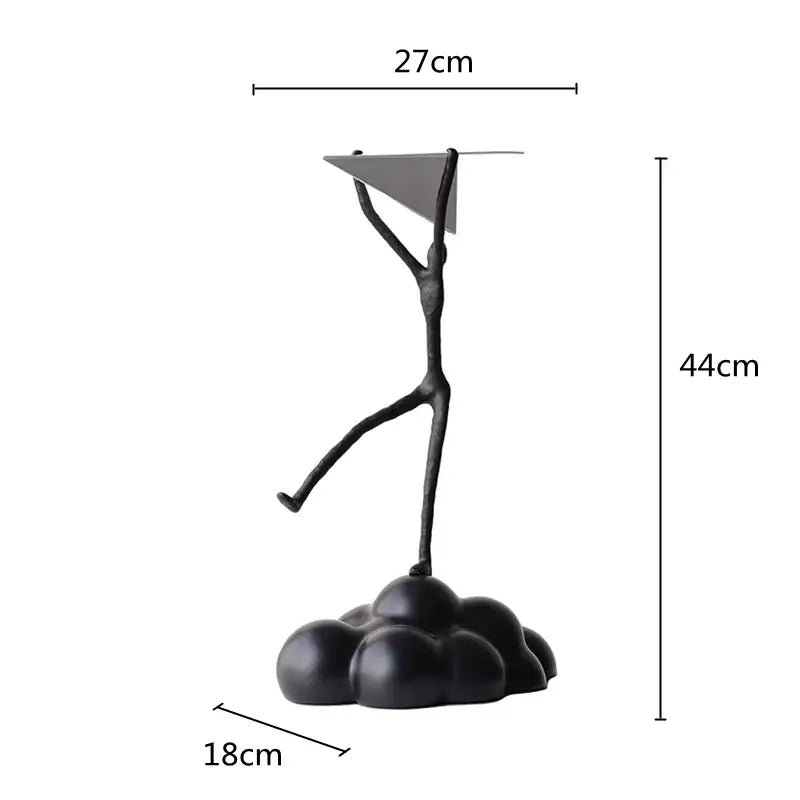 Black resin paper airplane cloud figurine with abstract metal sculpture balancing triangular plate for living room decor