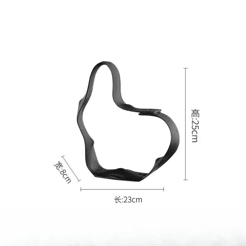 Black leather-like thumbs-up cookie cutter 23cm by 8cm paired with abstract black resin ring sculpture home decor decorbites geometric