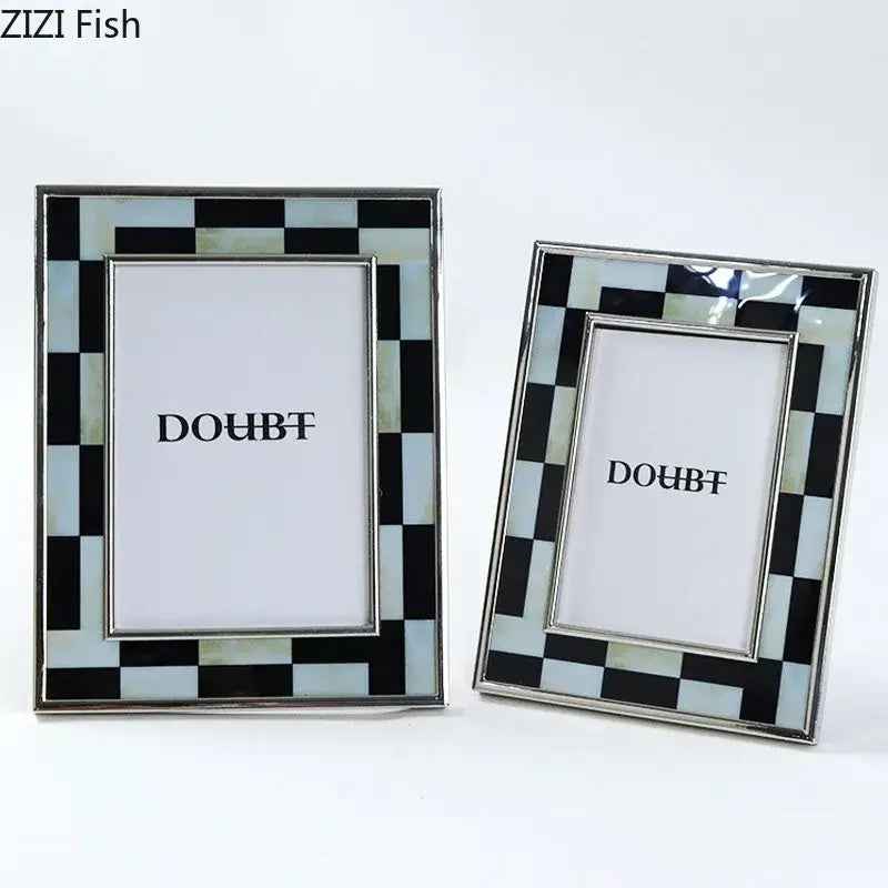 Two rectangular photo frames with black and white plaid mother-of-pearl inlay and silver-toned decorbites black white borders