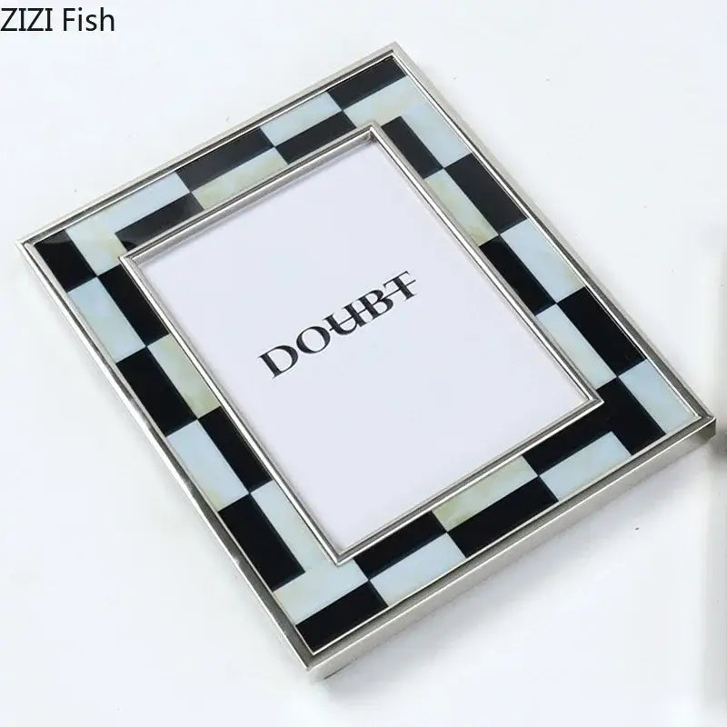 A sleek black and white plaid photo frame with mother-of-pearl inlays and polished silver edges for desktop decorbites decor