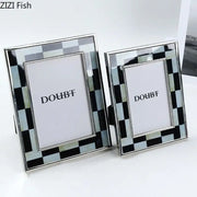 Two elegant black and silver checkered photo frames with a sleek metallic finish for bedroom desktop decorbites black white decor