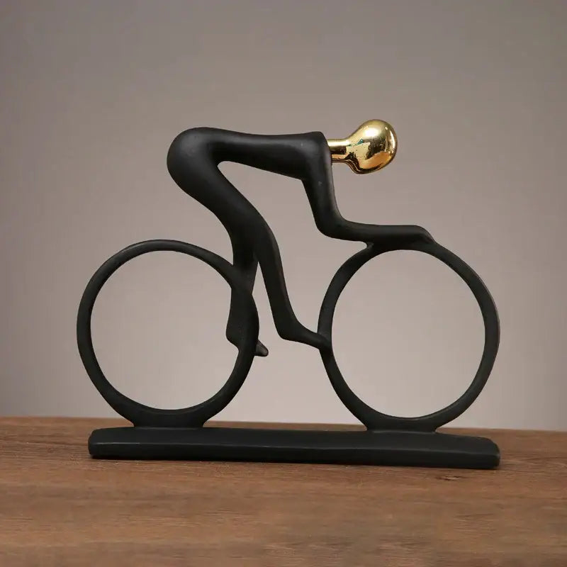 Black sculptural cyclist statue with gold-colored head and glossy finish decorbites abstract resin living room decor