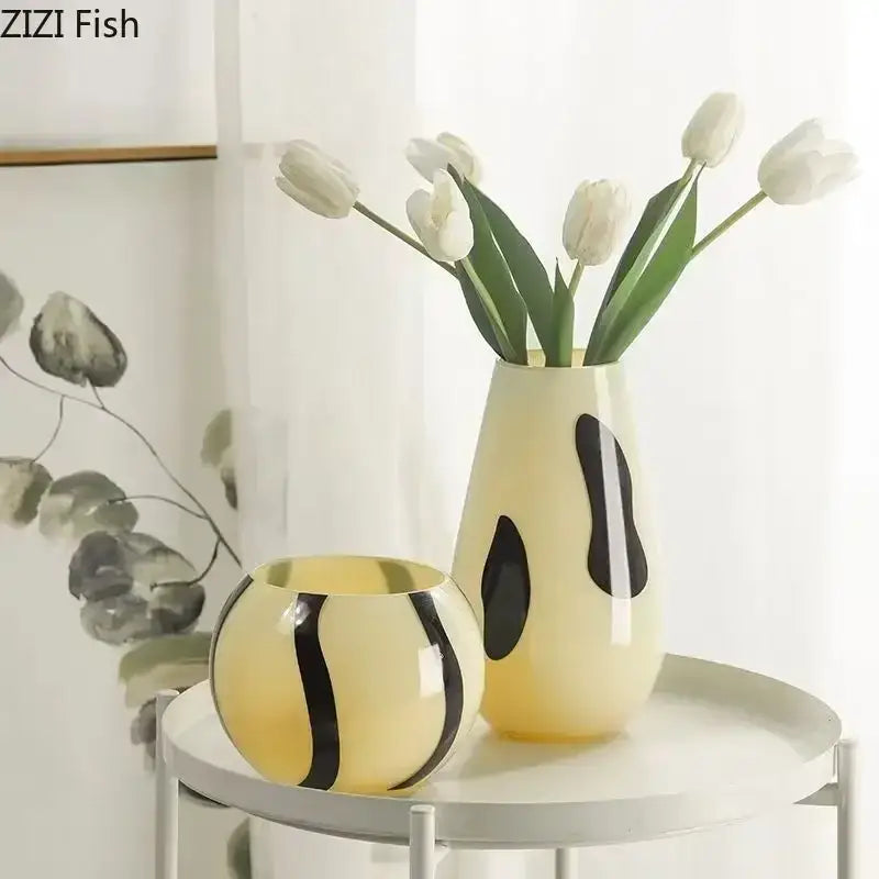 Cream ceramic vase with bold black stripes holding white tulips ideal for decorbites black stripes living room decor