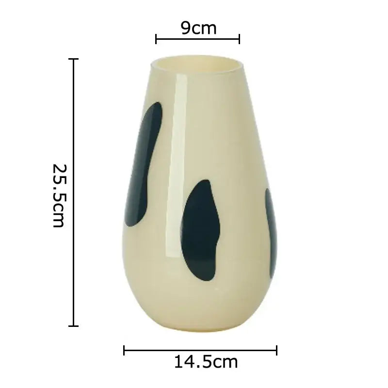 Cream-colored ceramic vase with three dark blue abstract leaf decals for living room decor featuring black stripes